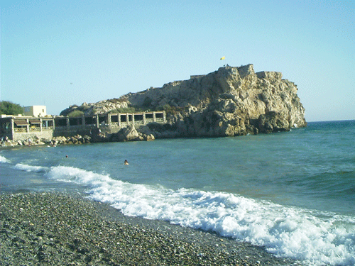 Rocky outcrop at salobrena beach with restaurant